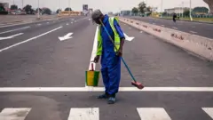 Man wey dey paint zebra crossing for road
