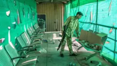 An Afghan army soldier surveys belongings left by the US military inside the Bagram Air Base, some 50 kilometers north of the capital Kabul.