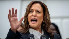 Kamala Harris raising her hand during a speech