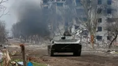 Ingabo zishyigikiye Uburusiya zirimo kugenda mu gifaru mu mirwano hagati y'ingabo za Ukraine n'ingabo z'Uburusiya, hafi y'uruganda rutunganya ibyuma rwa Azovstal mu mujyi wo mu majyepfo wa Mariupol, muri Ukraine, ku itariki ya 12 y'ukwezi kwa kane mu 2022