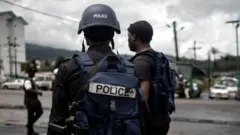 Cameroonian policemen dey patrol de market for de majority English-speaking South West province for Buea