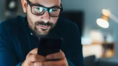 man typing on a phone