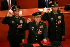 Zhang Youxia (C), newly-elected Vice Chairman of the Central Military Commission of the People's Republic of China, swears an oath with Central Military Commission members He Weidong and Li Shangfu after they were elected during the fourth plenary session of the National People's Congress (NPC) at the Great Hall of the People in Beijing on March 11, 2023.