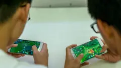 2 boys playing mobile games