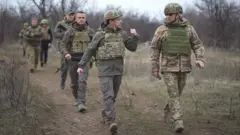 President Zelensky (front L) visited Ukrainian troops in the conflict zone on 8-9 April