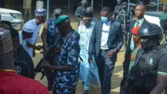 Security surround Nasir El-Rufai inside courtyard on April 21, 2026 