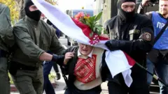 Law enforcement officers detain an opposition activist Nina Baginskaya