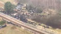 Footage showing hundreds of migrants gathering on the Belarusian side of the border on Monday