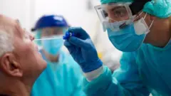 Hemşire test için hastadan örnek alıyor 