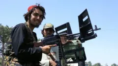 Taliban forces patrol a street in Herat, Afghanistan