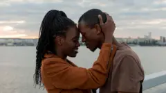 A man and a woman locking heads