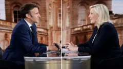 TV image of Emmanuel Macron and Marine Le Pen