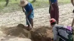 Two people digging