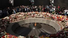People take part in a commemorative ceremony for 1.5 million Armenians killed in the Ottoman-era slaughter at the Tsitsernakaberd Armenian Genocide Memorial complex in Yerevan, Armenia, 24 April 2021
