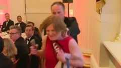 Mark Field walking the female protester out