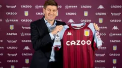 Steven Gerrard holds up an Aston Villa shirt