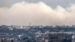 A cloud of smoke covers the skyline of Gaza