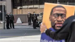 Protester and guard outside courtroom