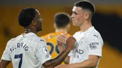 Phil Foden celebrates with Raheem Sterling