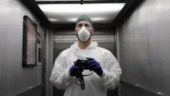 A member of hospital staff with a camera