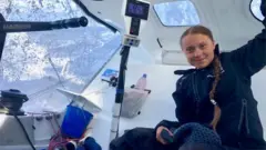 A handout photo made available by Swedish climate activist Greta Thunberg"s twitter account shows her onboard the racing boat Malizia II in the Atlantic Ocean, 24 August 2019