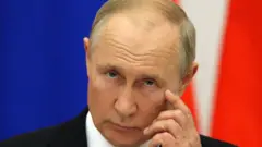 Vladimir Putin with hand to face