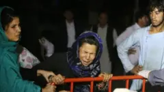 A woman cries outside a hospital after the blast