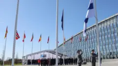 Officials attend a flag-raising ceremony for Finland's accession at the NATO foreign ministers' meeting at the Alliance's headquarters in Brussels, Belgium April 4, 2023