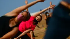 People participate in a morning yoga session