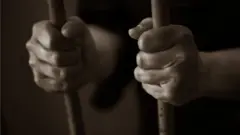 Man hold cell bar