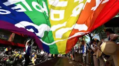Apoiadores da comunidade LGBTQ desfilam com uma bandeira do arco-íris durante o Festival de Cultura Queer de Seul em 14 de junho de 2025 em Seul, na Coreia do Sul