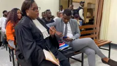 Ishimwe Dieudonne uzwi cyane nka Prince Kid (iburyo) hamwe n'umwunganizi we Emeline Nyembo mu rukiko i Kigali kuwa gatanu