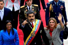 Maduro entre Delcy Rodriguez e sua esposa Cilia Flores, em sua posse de 2018