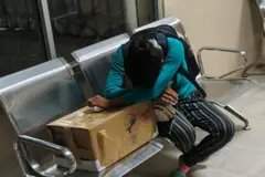 Yawa Sumpa Puar Alexandra llora sobre la caja de cartón que contiene los restos de su bebé de un mes. 