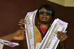 Woman holding ballot papers