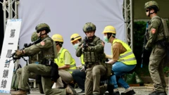 Los equipos de rescate y los voluntarios aseguran una instalación de telecomunicaciones mientras participan en el ejercicio de resiliencia urbana tras el simulacro de ataque aéreo.