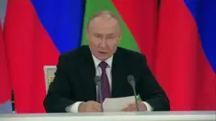 Vladimir Putin, um homem branco, parcialmente calvo, de terno
