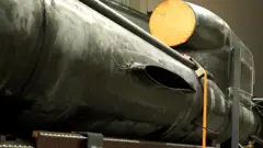 Um míssil Flamingo incompleto repousa em uma fábrica em Kiev — um corpo longo e preto com um motor na parte superior.