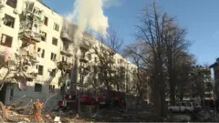 Smoke emerges from residential building after bombing