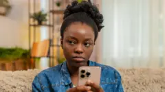 A lady typing on her phone