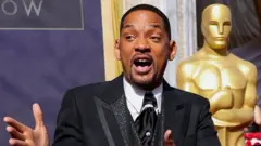 Will Smith in front of a giant Oscars statuette before the ceremony