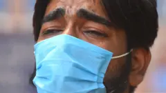 NEW DELHI, INDIA - APRIL 26: A relative of Covid-19 patient cries as he waits for admission at Lok Nayak Jai Prakash (LNJP) hospital, on April 26, 2021 in New Delhi, India. (Photo by Raj K Raj/Hindustan Times via Getty Images)