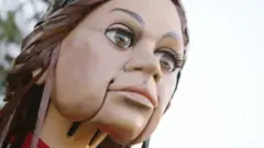 دمية عملاقة تسير في رحلة عبر أوروبا لإيصال رسالة عن اللاجئين