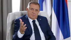 Политик в синем пиджаке смотрит в камеру