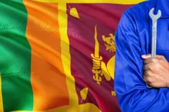 Sri Lankan Mechanic in blue uniform is holding wrench against waving Sri Lanka flag background