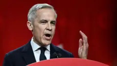 Mark Carney speaking wit im hand up