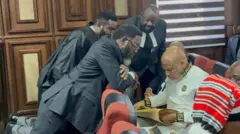 Nnamdi Kanu lawyers surround am for inside di courtroom for di Federal High Court Abuja - 16 October, 2025.