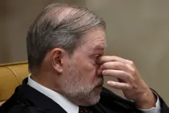 Toffoli com uma mão no rosto, coçando os olhos