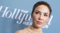 Whitney Cummings, pictured in front of a board saying 'The Hollywood Reporter'
