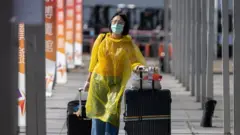 An air passenger wearing protective equipment in Hong Kong, China
